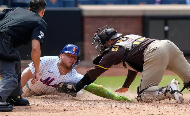 New York Mets designated hitter Francisco Alvarez is tagged out by San Diego Padres catcher Luis Campusano at home base during the seventh inning of a baseball game, Wednesday, Aug. 19, 2026, in New York. (AP Photo/Yuki Iwamura)