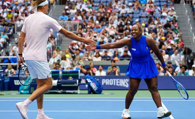 Alexander Zverev, of Germany, left, and Taylor Townsend, of the United States, high-five during a mixed doubles match at the U.S. Open tennis championships, Tuesday, Aug. 25, 2026, in New York. (AP Photo/Yuki Iwamura)