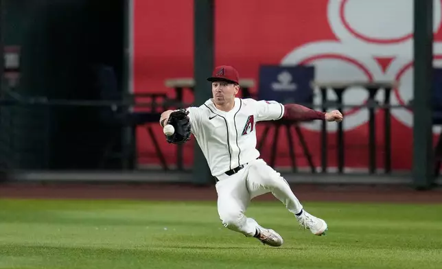 Arizona Diamondbacks right fielder Corbin Carroll makes a diving catch on a line drive hit by Chicago Cubs' Pedro Ramírez during the second inning of a baseball game, Tuesday, Aug. 25, 2026, in Phoenix. (AP Photo/Ross D. Franklin)