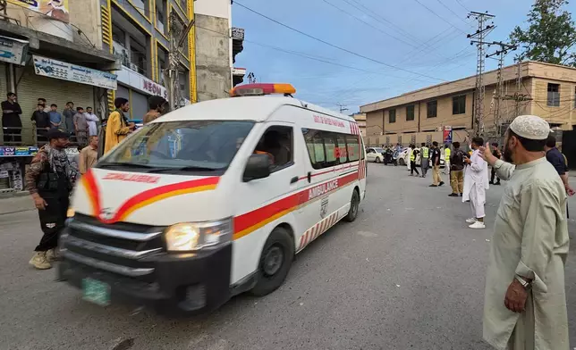 An ambulance rushes towards the hospital carrying injured victims from the site of a suicide bombing, in Kabal, a town in the Swat Valley in Pakistan's Khyber Pakhtunkhwa province, Sunday, Aug. 2, 2026. (AP Photo/Sherin Zada)