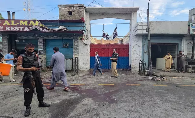 Police officers examine the site following a suicide bombing, in Kabal, a town in the Swat Valley in Pakistan's Khyber Pakhtunkhwa province, Sunday, Aug. 2, 2026. (AP Photo/Sherin Zada)