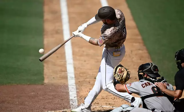 San Diego Padres' Jackson Merrill hits a single during the seventh inning of a baseball game against the San Francisco Giants, Sunday, Aug. 2, 2026, in San Diego. (AP Photo/Denis Poroy)