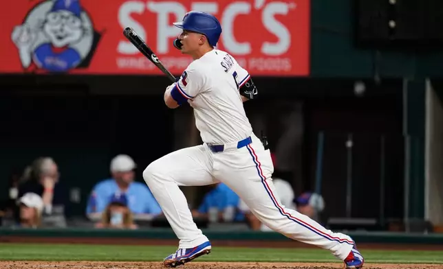 Texas Rangers' Corey Seager follows through on a double in the fifth inning of a baseball game against the Washington Nationals Thursday, Aug. 20, 2026, in Arlington, Texas. (AP Photo/Tony Gutierrez)