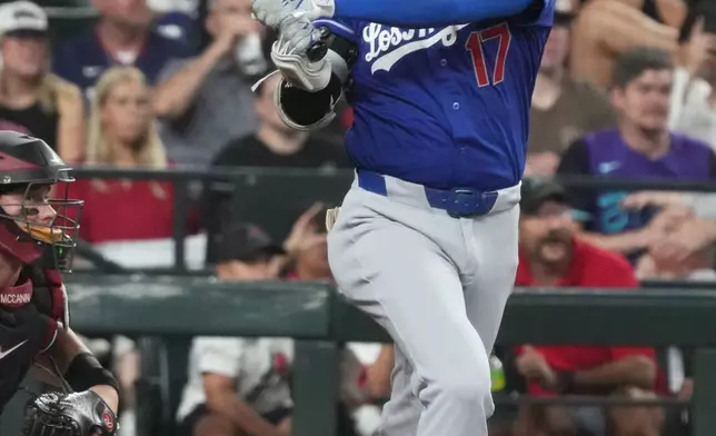 Los Angeles Dodgers' Shohei Ohtani hits against the Arizona Diamondbacks in the fourth inning of a baseball game, Saturday, Aug 8, 2026, in Phoenix. (AP Photo/Rick Scuteri)