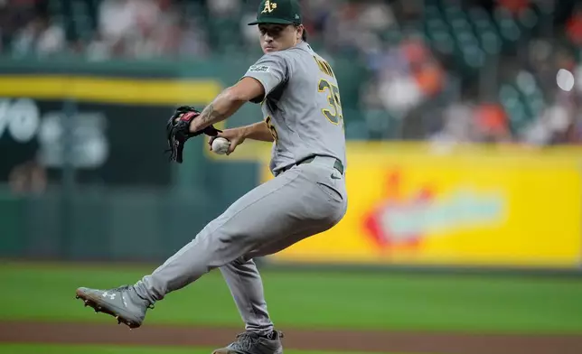 Athletics pitcher J.T. Ginn delivers during the first inning of a baseball game against the Houston Astros, Friday, Aug. 21, 2026, in Houston. (AP Photo/Kevin M. Cox)