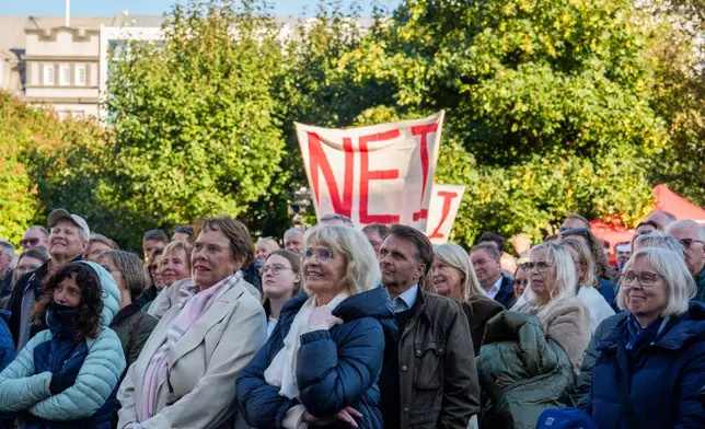 People hold a banner reading "No" as they listen to speakers at an "Afram Island," "Forward, Iceland," rally opposing the resumption of European Union accession talks at Austurvollur in Reykjavik, Iceland, Thursday, Aug. 27, 2026. (AP Photo/Marco Di Marco)