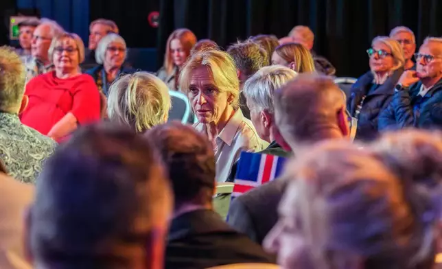 Icelandic Foreign Minister Thorgerdur Katrín Gunnarsdottir, center, sits among the participants at a public event about a referendum on whether to resume accession negotiations with the European Union in Reykjavik, Iceland, Wednesday, Aug. 26, 2026. (AP Photo/Marco Di Marco)