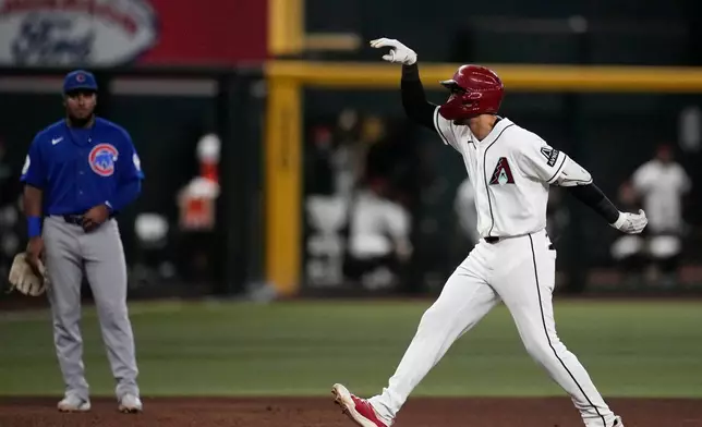 Arizona Diamondbacks' Jordan Lawlar, right, celebrates his home run as he runs past Chicago Cubs third baseman Pedro Ramírez, left, during the sixth inning of a baseball game, Wednesday, Aug. 26, 2026, in Phoenix. (AP Photo/Ross D. Franklin)