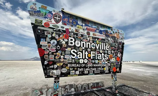 Racing stickers cover a sign for Utah’s Bonneville Salt Flats, home to a speedway where several land speed records have been set, Monday, Aug. 10, 2026. (AP Photo/Hannah Schoenbaum)