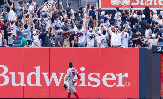 Boston Red Sox left fielder Jarren Duran (16) watches fans react after New York Yankees' Heliot Ramos hit a three-run home run, also scoring Paul Goldschmidt and Cody Bellinger, in the fifth inning of a baseball game, Sunday, Aug. 30, 2026, in New York. (AP Photo/Corey Sipkin)