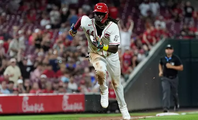 Cincinnati Reds shortstop Elly De La Cruz runs to home plate to score on a wild pitch by Athletics pitcher Hogan Harris in the eighth inning of a baseball game in Cincinnati, Tuesday, Aug. 4, 2026. (AP Photo/Carolyn Kaster)