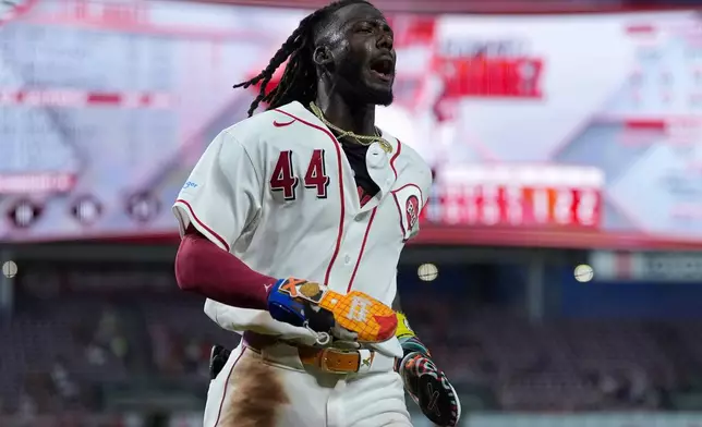 Cincinnati Reds shortstop Elly De La Cruz reacts as he scores on a wild pitch by Athletics pitcher Hogan Harris in the eighth inning of a baseball game in Cincinnati, Tuesday, Aug. 4, 2026. (AP Photo/Carolyn Kaster)