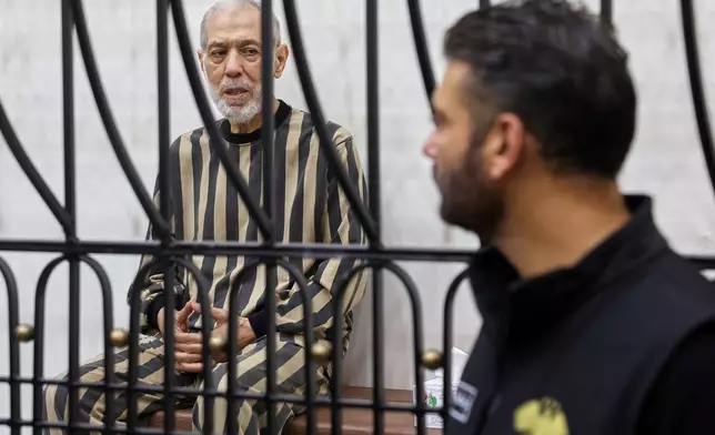 Syria's former grand mufti under ousted President Bashar Assad, Ahmad Badreddine Hassoun, sits in the defendants' cage before a court sentences him to life in prison at the Palace of Justice in Damascus, Syria, Monday, Aug. 24, 2026. (AP Photo/Ghaith Alsayed)