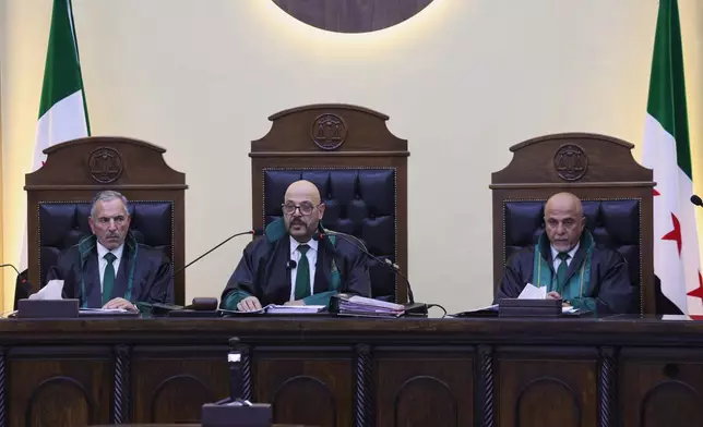 Judge Fakhreddine al-Aryan, center, head of the Fourth Criminal Court, reads the ruling sentencing Syria's former grand mufti under ousted President Bashar Assad, Ahmad Badreddine Hassoun, to life in prison at the Palace of Justice in Damascus, Syria, Monday, Aug. 24, 2026. (AP Photo/Ghaith Alsayed)