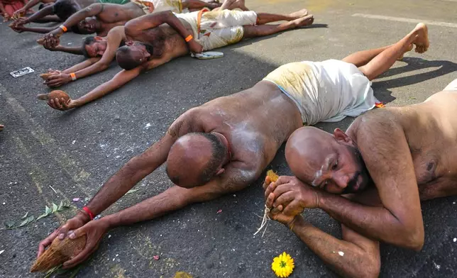 Worshippers perform an act of sacrifice as they take part in the Hindu Chariot Festival, a celebration to worship the Hindu god Amman, in London, Sunday, Aug. 9, 2026. (AP Photo/Kirsty Wigglesworth)