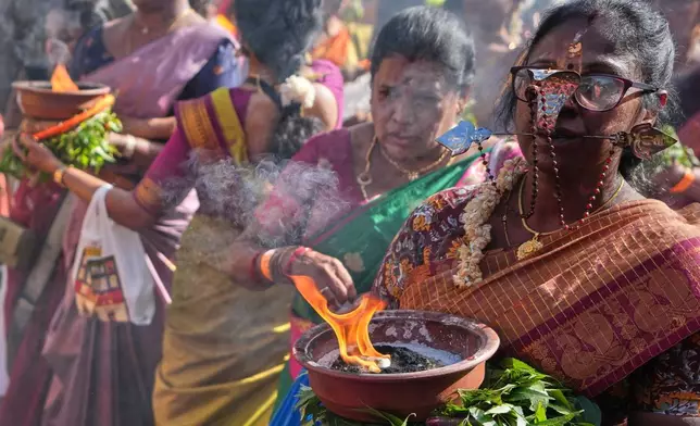 Women take part in the Hindu Chariot Festival, a celebration to worship the Hindu god Amman, in London, Sunday, Aug. 9, 2026. (AP Photo/Kirsty Wigglesworth)