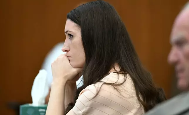 Lindsay Clancy, center, and her lawyer Kevin Reddington, right, listen during testimony during Clancy's murder trial, Thursday, Aug. 13, 2026., in Plymouth, Mass. (AP Photo/Josh Reynolds, Pool)