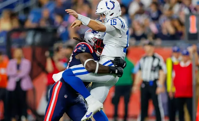 Indianapolis Colts quarterback Riley Leonard, right, is hit after the pass by New England Patriots linebacker Jesse Luketa during the second half of an NFL preseason football game, Thursday, Aug. 13, 2026, in Foxborough, Mass. (AP Photo/CJ Gunther)