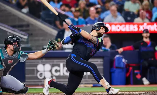Toronto Blue Jays' Nathan Lukes, right, watches his solo home run against the Seattle Mariners during the fifth inning of a baseball game in Toronto, Friday, Aug. 28, 2026. (Sammy Kogan/The Canadian Press via AP)