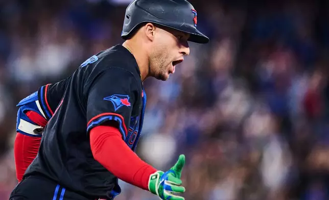 Toronto Blue Jays' George Springer reacts as he rounds the bases after hitting a solo home run during the fifth inning of a baseball game against the Seattle Mariners in Toronto, Friday, Aug. 28, 2026. (Sammy Kogan/The Canadian Press via AP)