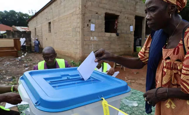 A voter casts her ballot during a referendum on granting new presidential powers, in Bissau, Guinea Bissau, Sunday, Aug. 30, 2026. (AP Photo/Darcicio Barbosa)