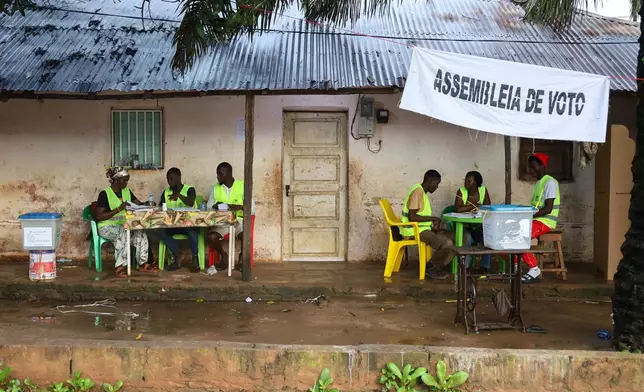 Election officials wait for voters to cast their ballots during a referendum on granting new presidential powers, in Bissau, Guinea Bissau, Sunday, Aug. 30, 2026. (AP Photo/Darcicio Barbosa)