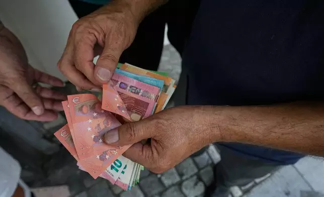 A money exchanger counts Euro bank notes at Ferdowsi square, Tehran's go-to venue for foreign currency exchange, in downtown Tehran, Iran, Monday, Aug. 24, 2026. AP Photo/Vahid Salemi)