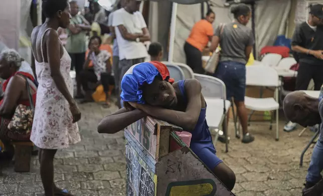A girl rests at a shelter for families displaced by gang violence in Port-au-Prince, Haiti, Wednesday, Aug. 12, 2026. (AP Photo/Odelyn Joseph)