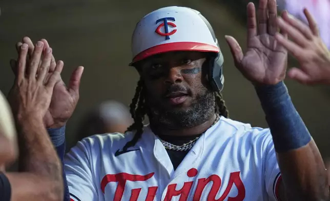Minnesota Twins designated hitter Josh Bell celebrates in the dugout after scoring off a RBI single hit by Kody Clemens during the first inning of a baseball game against the Atlanta Braves, Monday, Aug. 17, 2026, in Minneapolis. (AP Photo/Abbie Parr)