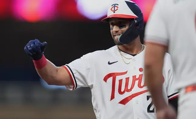 Minnesota Twins' Royce Lewis celebrates after hitting a RBI single during the first inning of a baseball game against the Atlanta Braves, Monday, Aug. 17, 2026, in Minneapolis. (AP Photo/Abbie Parr)