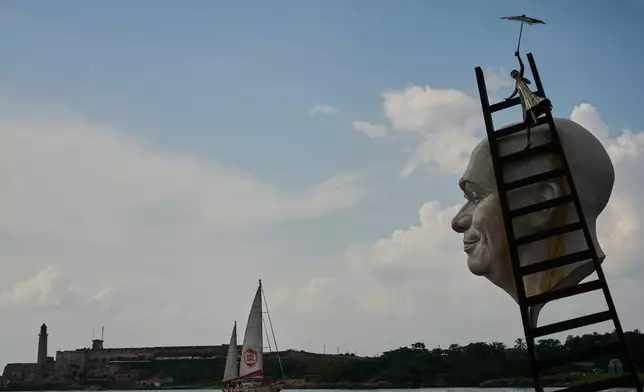 Artwork by Cuban Osmany Betancourt stands on exhibit in Havana Bay where the Astral ship from the Spanish humanitarian organization Open Arms arrives, in Cuba, Sunday, July 19, 2026. (AP Photo/Ramon Espinosa)