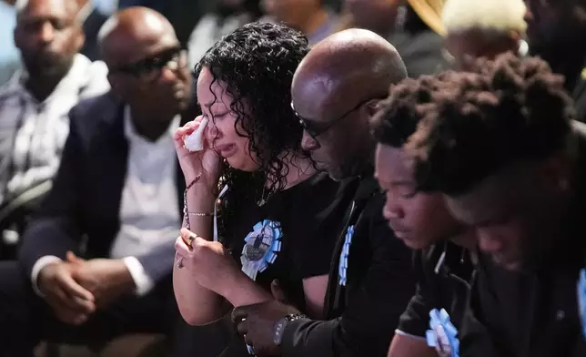 From left to right, Christine Wonsley cries next to her Husband Elmore, and their sons Elmore Jr. and Ethan during a memorial service for her son Nolan Xavier Wells, an 18-year-old found dead after taking a July 4 boat trip with friends, Monday, July 20, 2026, in Ocean Springs, Miss. (AP Photo/Gerald Herbert)