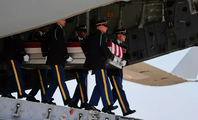 A U.S. Army carry team moves a transfer case containing the remains of 1st Lt. Tyler James Feehan of Ewa Beach, Hawaii, Wednesday, July 22, 2026, at Dover Air Force Base, Del. (AP Photo/Matt Rourke)