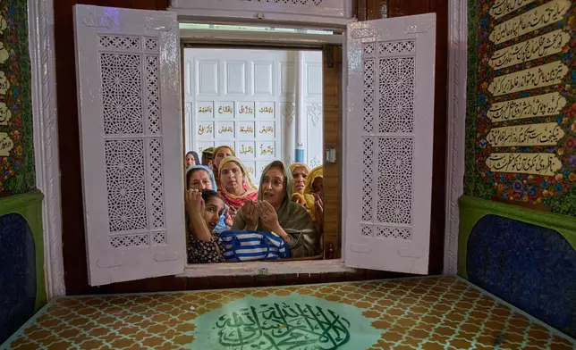 Kashmiri Muslim women pray inside the shrine of Sufi saint Hazrat Sheikh Hamza Makhdoom, during the annual commemoration of the saint in Srinagar, Indian-controlled Kashmir, Saturday, Aug. 8, 2026. (AP Photo/Dar Yasin)