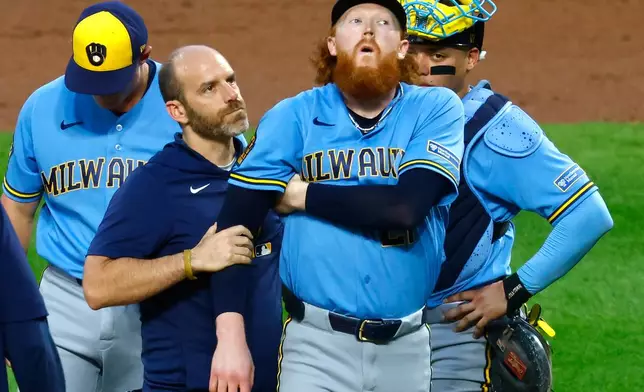Milwaukee Brewers pitcher Dustin May reacts after being hit by a batted ball during the first inning of a baseball game against the New York Mets, Wednesday, Aug. 26, 2026, in New York. (AP Photo/Noah K. Murray)