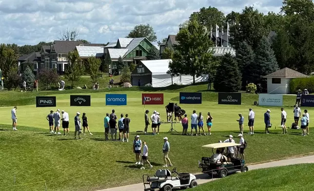 LIV Golf fans gather at the practice putting green before the final round of the season-ending event in suburban Indianapolis, Ind., Sunday, Aug. 23, 2026. (AP Photo/Michael Marot)