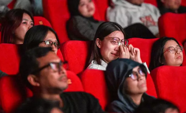 In this photo released by Xinhua News Agency, audience react to the Chinese film "Dear You" during its premiere in Jakarta, Indonesia, on Aug. 5, 2026. (Agung Kuncahya B./Xinhua via AP)