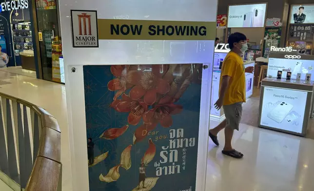 A man walks past a poster for the movie "Dear You" at a shopping mall in Rayong, Thailand, on Aug. 10, 2026. (AP Photo/Sakchai Lalit)