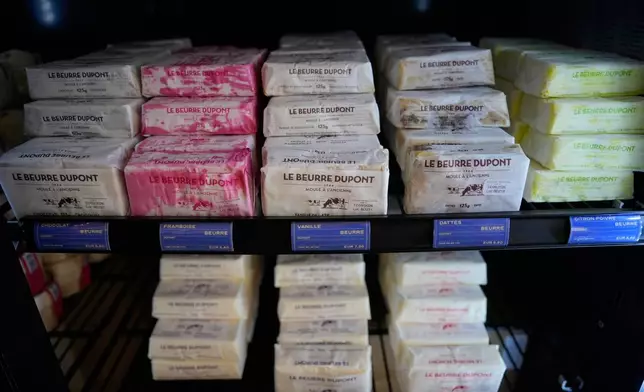Packs of butter with different flavors are displayed in a refrigerator at Le Butter Shop, the first shop devoted entirely to butter in Paris, France, Tuesday Aug. 25, 2026. (AP Photo/Christophe Ena)