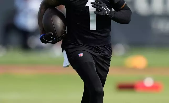 Houston Texans wide receiver Tank Dell works out during the team's NFL football training camp in Houston, Friday, August 7, 2026. (AP Photo/Ashley Landis)
