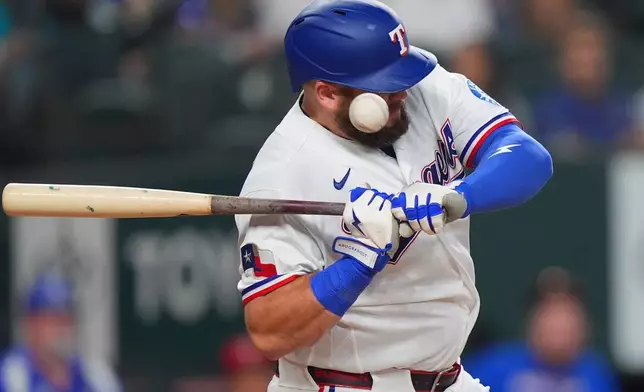 Texas Rangers' Jake Burger is hit by a pitch during the third inning of a baseball game against the Los Angeles Angels, Saturday, Aug. 22, 2026, in Arlington, Texas. (AP Photo/LM Otero)