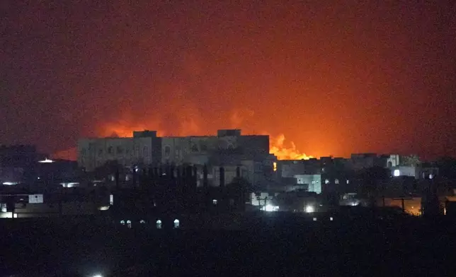 Flames and smoke rise from the port of Mokha during a strike in Yemen, Friday, Aug. 14, 2026. (AP Photo/Abdulnasser Alseddik)