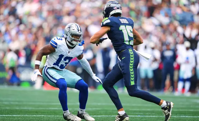 Dallas Cowboys safety Caleb Downs (13) defends as Seattle Seahawks wide receiver Jake Bobo (19) runs a route in the first half of an NFL preseason football game, Saturday, Aug. 15, 2026, in Seattle. (AP Photo/Lindsey Wasson)