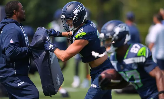 Seattle Seahawks wide receiver Jake Bobo runs a blocking drill during the NFL football team's training camp, Thursday, Aug. 13, 2026, in Renton, Wash. (AP Photo/Lindsey Wasson)