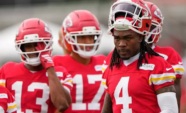 Kansas City Chiefs wide receiver Rashee Rice (4) waits with teammates to start a drill during NFL football training camp Friday, July 31, 2026, in St. Joseph, Mo. (AP Photo/Charlie Riedel)