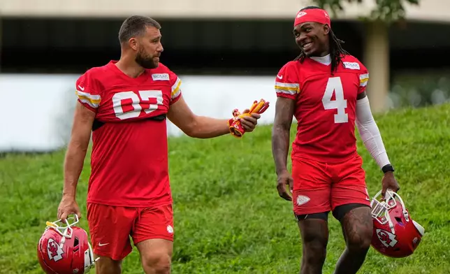 Kansas City Chiefs tight end Travis Kelce (87), and wide receiver Rashee Rice (4) walk to NFL football training camp Friday, July 31, 2026, in St. Joseph, Mo. (AP Photo/Charlie Riedel)