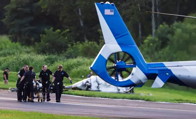 Authorities investigate a crash between a Pennsylvania State Police helicopter and a small plane at the Carlisle airport in Carlisle, Pa. Wednesday, Aug. 19, 2026. (Sean Simmers/The Patriot-News via AP)