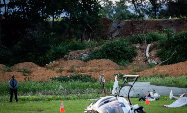 Authorities investigate a crash between a Pennsylvania State Police helicopter and a small plane at the Carlisle airport in Carlisle, Pa. Wednesday, Aug. 19, 2026. (Sean Simmers/The Patriot-News via AP)