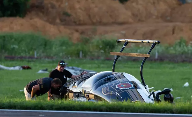 Authorities investigate a crash between a Pennsylvania State Police helicopter and a small plane at the Carlisle airport in Carlisle, Pa. Wednesday, Aug. 19, 2026. (Sean Simmers/The Patriot-News via AP)