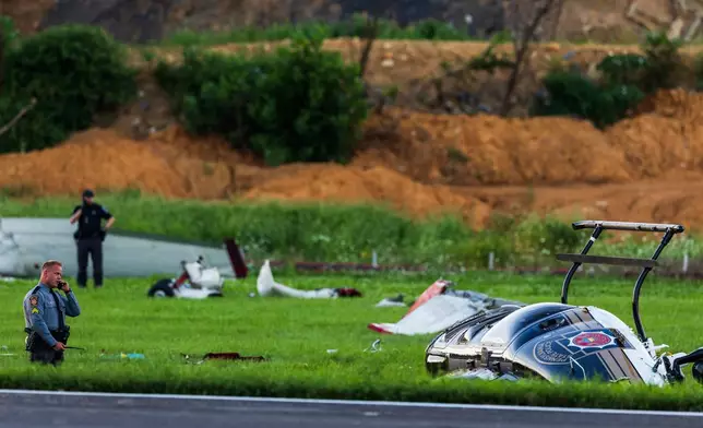 Authorities investigate a crash between a Pennsylvania State Police helicopter and a small plane at the Carlisle airport in Carlisle, Pa. Wednesday, Aug. 19, 2026. (Sean Simmers/The Patriot-News via AP)